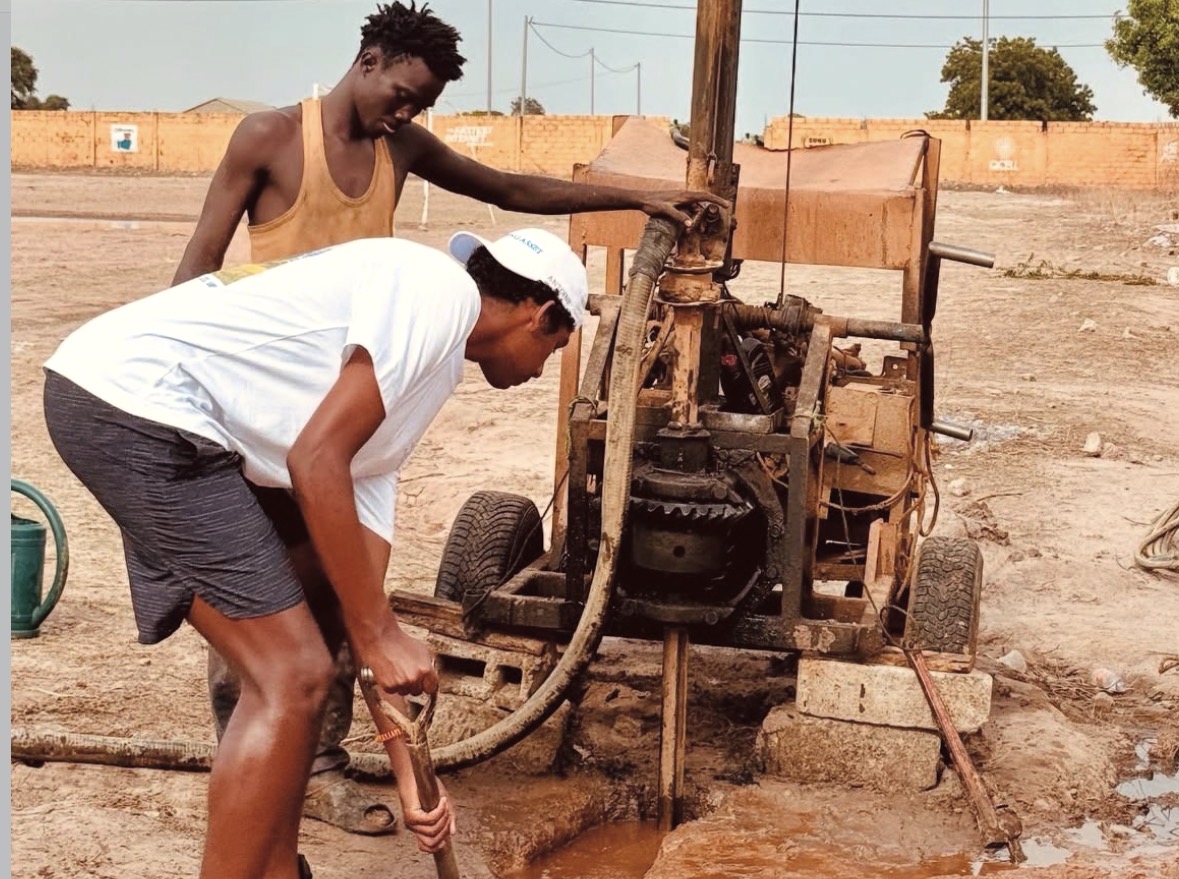 Workers drilling a borehole for clean water