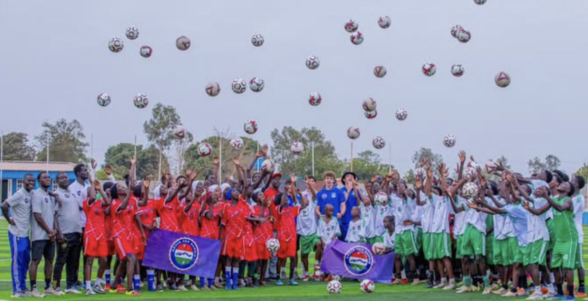 Campers throwing footballs in the air