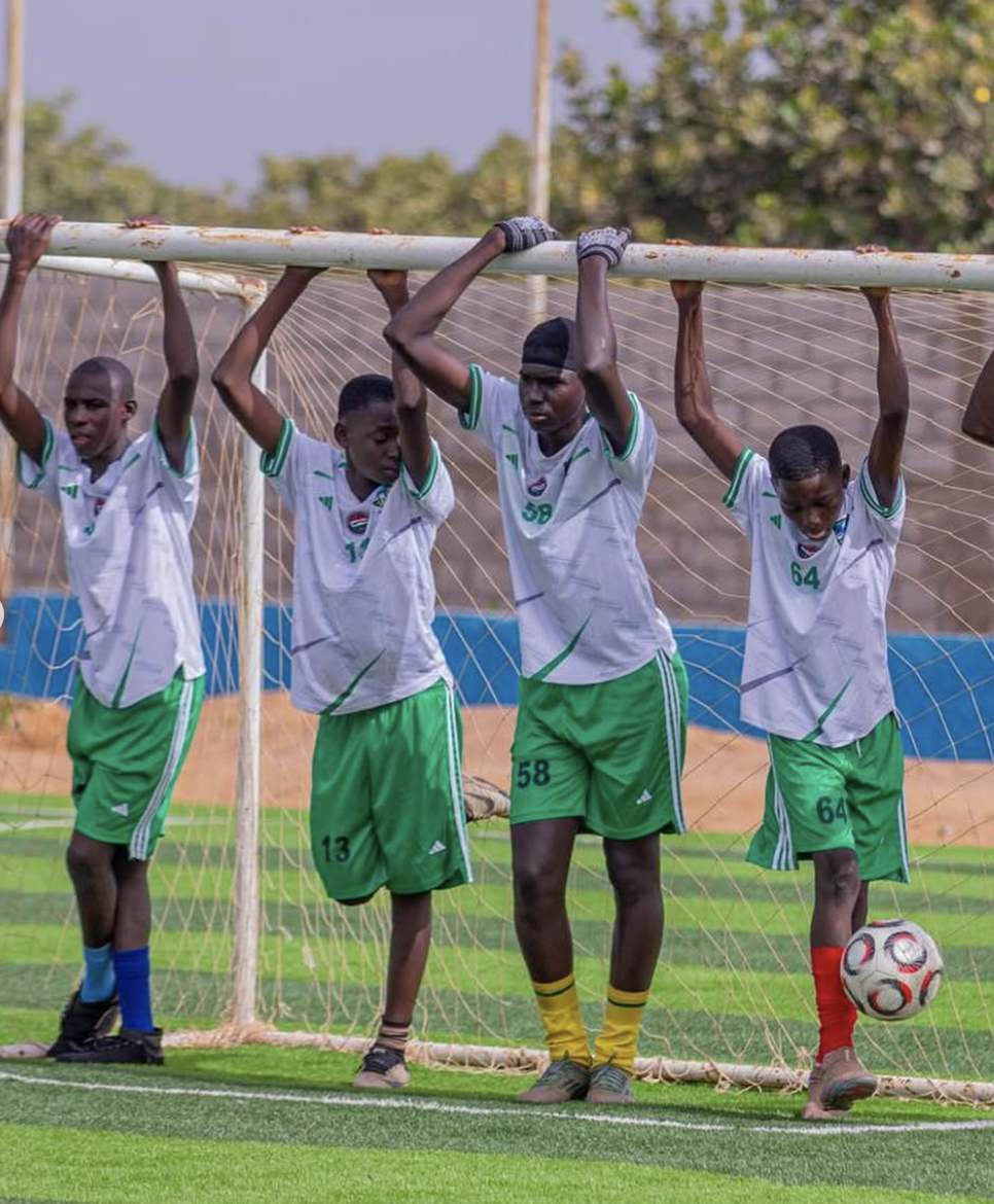 Players hanging from the goalpost