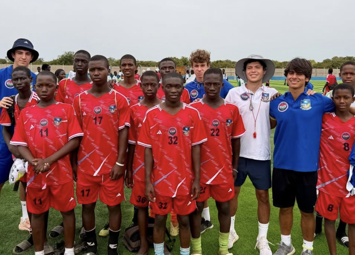 Handing out clothes to young players