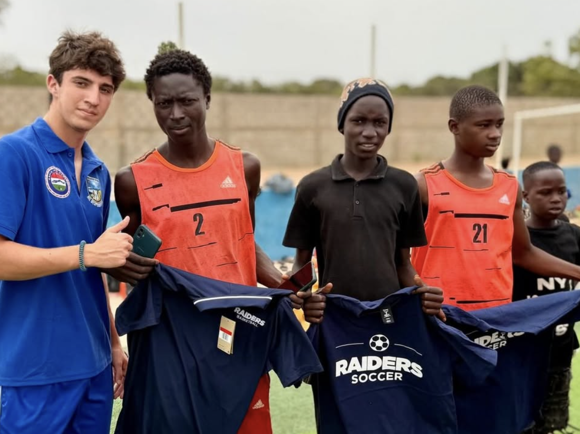 Players receiving Raiders Soccer jerseys