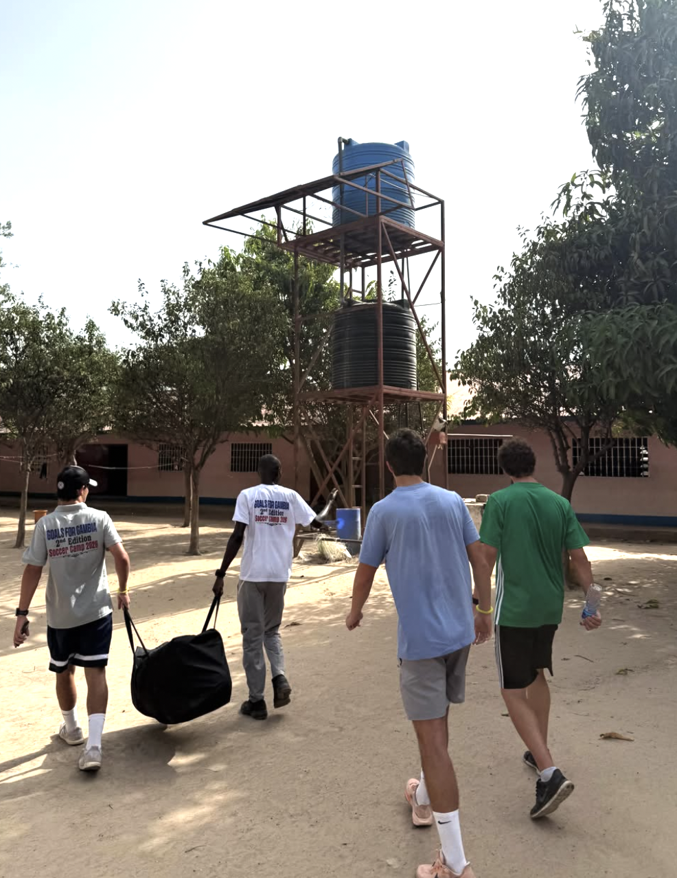 Team walking with equipment bags
