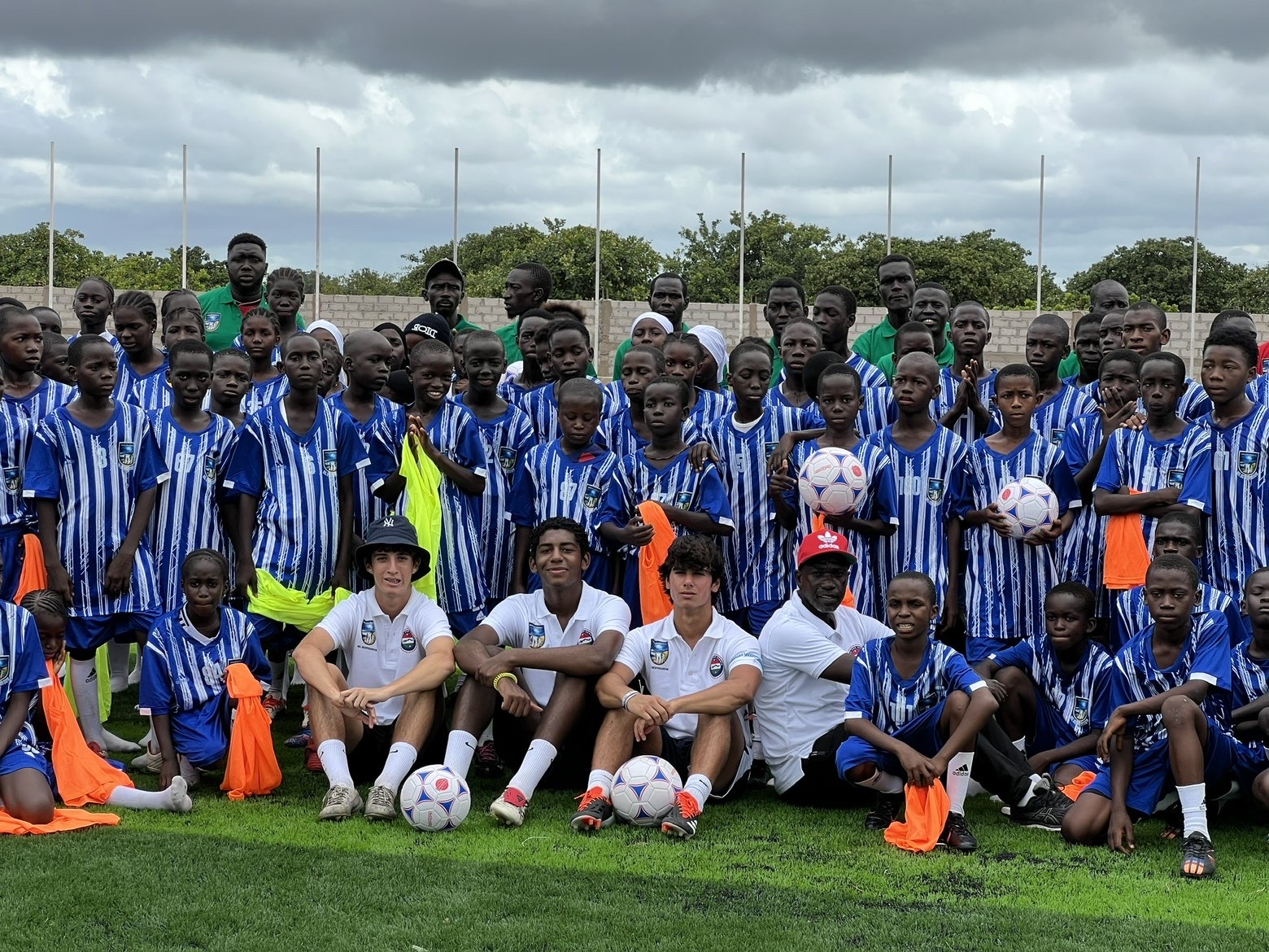 Group photo with young players holding footballs