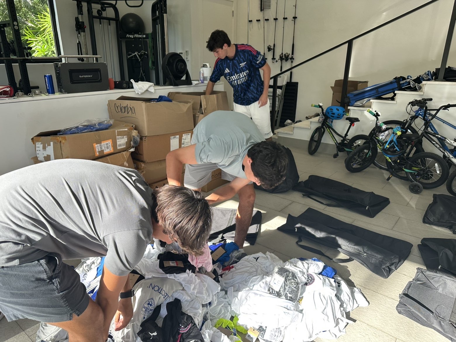 Team sorting clothing donations on the floor